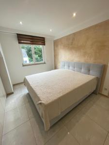 a bedroom with a large bed and a window at Stylish spacious residence in Düsseldorf in Düsseldorf