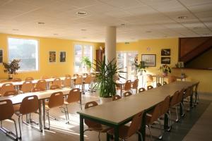 a large room with tables and chairs in it at Gîte des Grands Causses in Millau