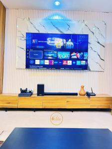 a large flat screen tv hanging on a wall at Shelve Apartments in Aja +5 photos