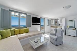 a living room with a couch and a chair at Caldera Cliff Illusion in Fira