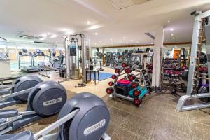 a gym with several treadmills and machines at Bromsgrove Hotel in Bromsgrove