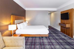 a hotel room with a bed and a couch at Bromsgrove Hotel in Bromsgrove