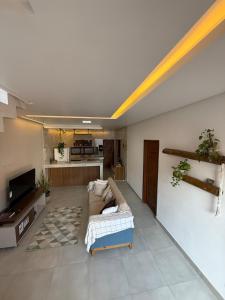 a living room with a couch and a tv at Casa Massa in Marechal Deodoro