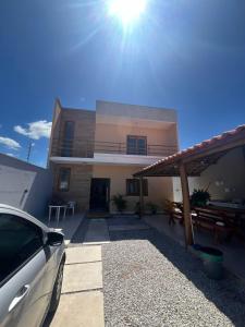 a car parked in front of a house at Casa Massa in Marechal Deodoro