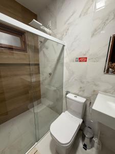 a bathroom with a shower and a toilet and a sink at Casa Massa in Marechal Deodoro +10 photos