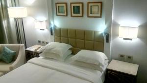 a bedroom with a white bed and two lamps at Sharm Dreams timeshare in Sharm El Sheikh