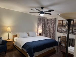 a bedroom with a bed with a ceiling fan at Historic Downtown McKinney 3BR in McKinney