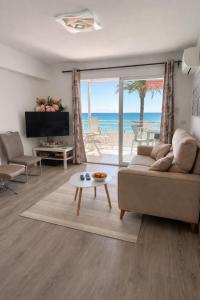 a living room with a couch and a view of the ocean at Altea Beach Apartment in Altea