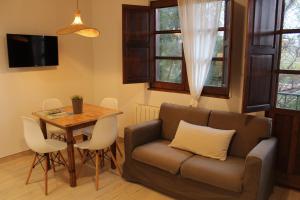 a living room with a couch and a table at Apartamentos Los Hidalgos in Santillana del Mar