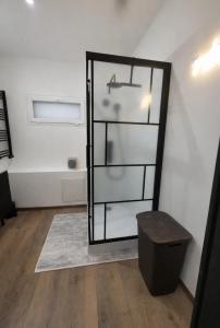 a mirror in a room with a wooden floor at Le Refuge Gabriel avec grand parking privé in Blois +18 photos