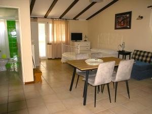 a living room with a table and a couch at House Rozi in Rab