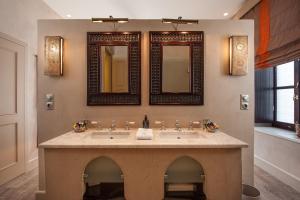 a bathroom with two sinks and two mirrors at La Maison Ottomane in Chania Town +48 photos