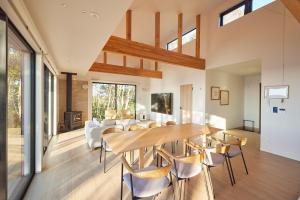 a dining room and living room with a table and chairs at UMIBE Terrace in Shima +33 photos