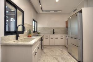 a kitchen with a sink and a refrigerator at Golden Estate - גולדן אסטייט in Safed