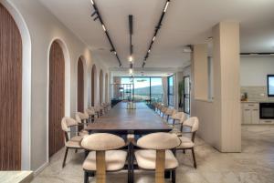 a long dining room with a long table and chairs at Golden Estate - גולדן אסטייט in Safed