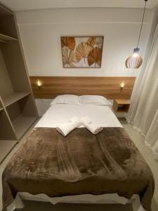 a bedroom with a bed with two towels on it at Beach Class Verano 01 A in Ipojuca +16 photos