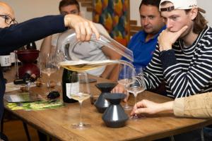 a woman pouring a glass of white wine at Les Randonneuses in Marcilly-sur-Seine