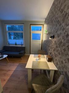 a living room with a table and a couch at Appartement Königshütte in Königshütte +9 photos