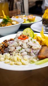 a plate of food with seafood and beans on a table at Amarena Resorts in Bocapán +29 photos