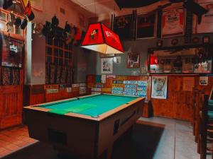 a ping pong table in a bar with a light at The Hermon Hotel in Hermon