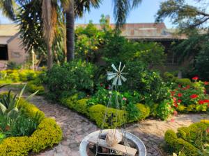 a garden with a cross in the middle of it at The Hermon Hotel in Hermon