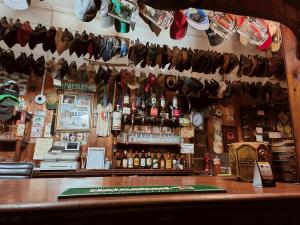 a bar with a lot of hats hanging from the wall at The Hermon Hotel in Hermon