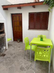 a yellow table and chairs in front of a house at AltaMar in Playa Unión