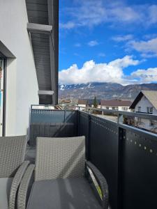a balcony with chairs and a view of the mountains at Apartment Čebelica in Lesce
