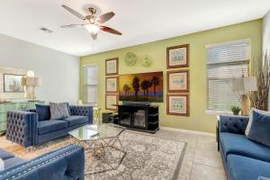 a living room with blue couches and a fireplace at Ev1339 - Sunset Palm Retreat in Davenport