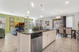 an open kitchen and dining room with a kitchen island at Ev1339 - Sunset Palm Retreat in Davenport