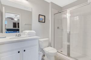 a white bathroom with a shower and a toilet at Ev1339 - Sunset Palm Retreat in Davenport +32 photos