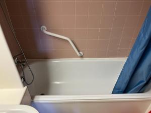 a bathroom with a tub and a toilet and a shower curtain at Bilocale Casa Canazei in Alba di Canazei