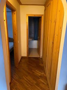 a hallway leading to a bathroom with a toilet at Bilocale Casa Canazei in Alba di Canazei