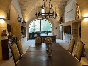 a large dining room with a long table and a chandelier at Château de Collias - Maison de Vacances in Collias