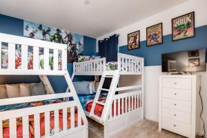 a childs room with two bunk beds at 10Br Retreat With Private Pool & Spa in Kissimmee +27 photos