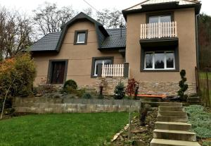 a house with a lawn in front of it at Apartmány Za Zvončekom in Vydrná