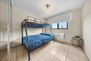 a bedroom with two bunk beds and a window at Beachfront Aquatika Resort- Style-Pools & Ocean in Rio Grande +21 photos