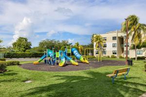 a playground in a park with a slide at Beachfront Aquatika Resort- Style-Pools & Ocean in Rio Grande