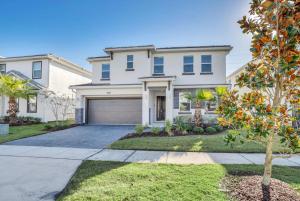 a large white house with a garage at Ev2613 - Grand Horizon Manor in Kissimmee