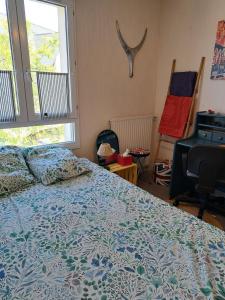a bedroom with a bed and a large window at Petite Chambre CHEZ MARINA in Chantepie