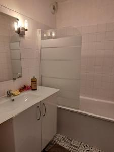 a bathroom with a sink and a tub and a mirror at Petite Chambre CHEZ MARINA in Chantepie +11 photos