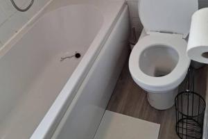 a bathroom with a white toilet in a stall at 3 Bed House Sleeps 5 - Free Parking - Tv & WiFi in Sheffield