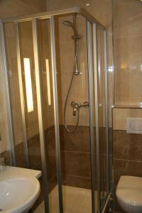 a bathroom with a shower and a toilet and a sink at Hotel Bellevue Saint-Lazare in Paris
