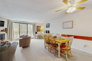 a living room with a table and chairs at Mad House in Waterville Valley