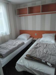 two beds sitting next to each other in a room at Escapade aux Peupliers in Vironchaux +2 photos
