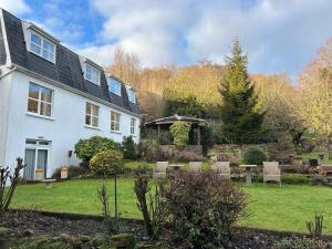 a white house with a garden in front of it at Belvedere Lodge in Cork