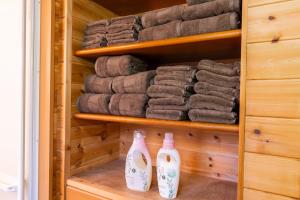 a closet filled with lots of towels and bottles at ふじのわ in Fujikawaguchiko +28 photos