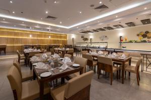a restaurant with tables and chairs and a bar at Petra Guest House Hotel in Petra +83 photos