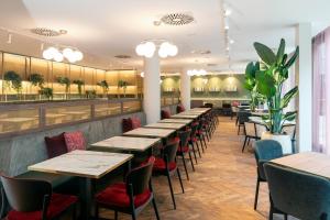 a row of tables and chairs in a restaurant at MAXX by Steigenberger Vienna in Vienna