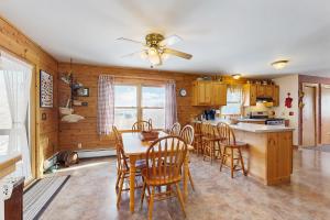 a kitchen and dining room with a table and chairs at North Hill Cabin in Jay